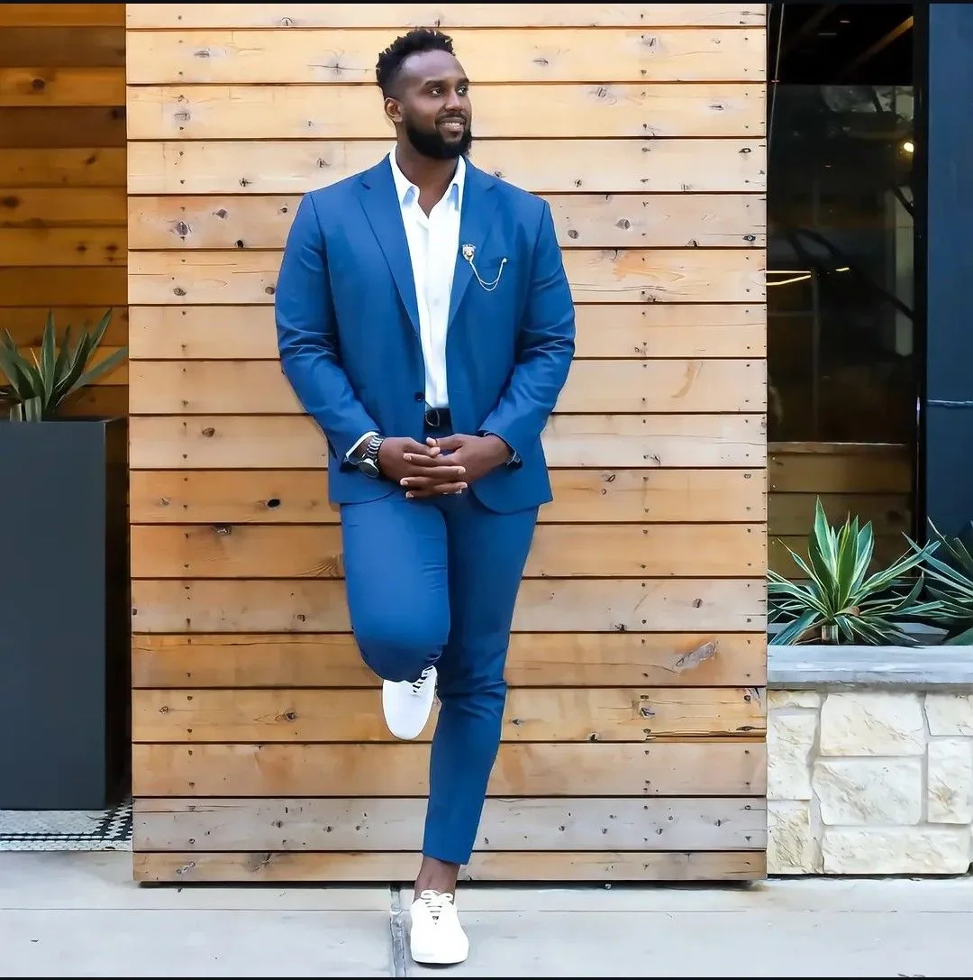 Tony Hills standing in a blue suit